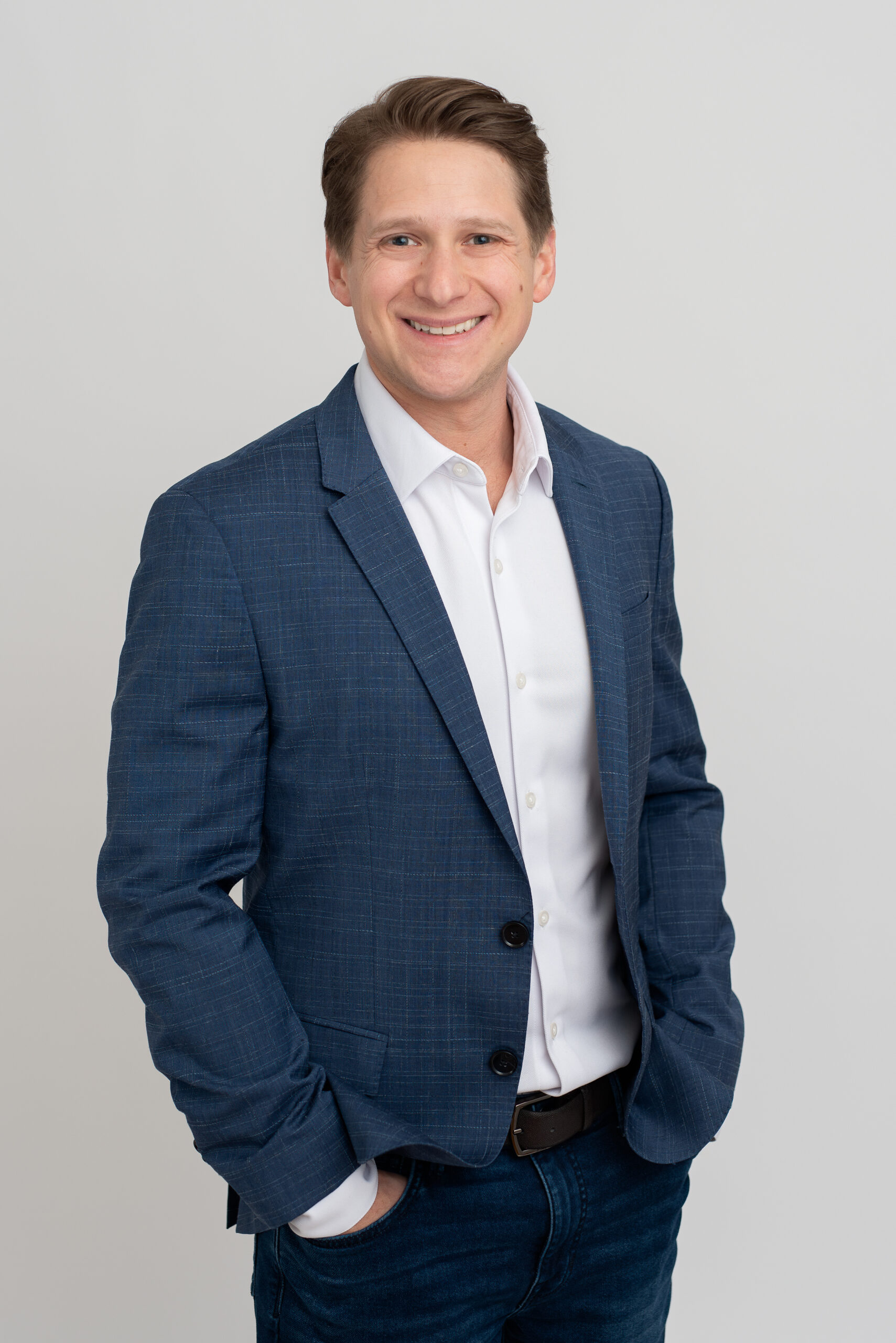 Man in blue blazer and white shirt, business portrait.