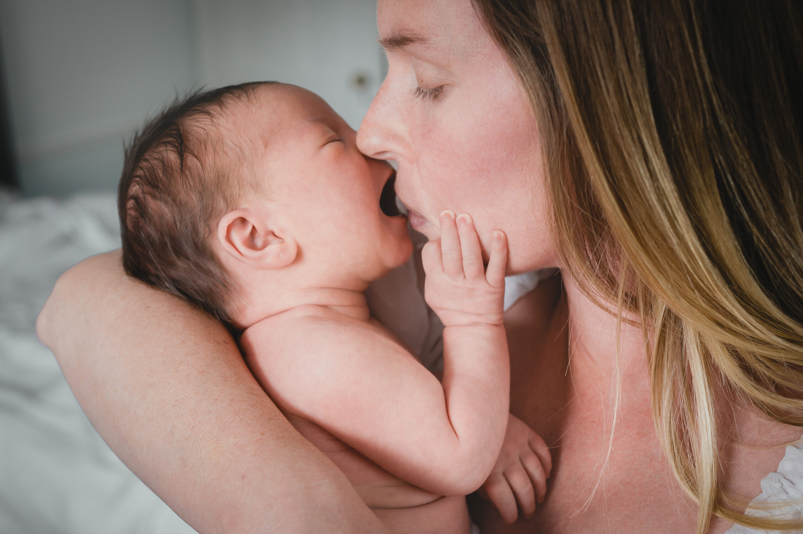 intimate moment between mom and newborn baby 